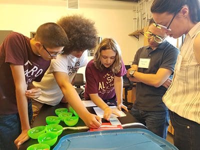 Scientists and students engaged in an interactive game 